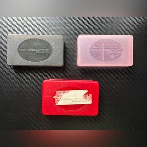 Nintendo DS Game Cases in Black, Pink, and Red